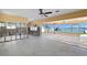 Large living area with waterfront views through oversized windows, perfect for entertaining at 844 Bay Point Dr, Madeira Beach, FL 33708