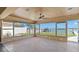 Enclosed patio with waterfront views through oversized windows, perfect for relaxing at 844 Bay Point Dr, Madeira Beach, FL 33708