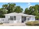 Charming single-story home with a well-maintained exterior, offering a welcoming curb appeal with a gray roof at 8513 Sunbeam Ln, Tampa, FL 33615