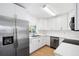 Bright kitchen featuring stainless steel appliances, white cabinets, and sleek countertops at 8513 Sunbeam Ln, Tampa, FL 33615