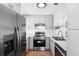Modern kitchen with stainless steel appliances, white cabinets, and ample counter space at 8513 Sunbeam Ln, Tampa, FL 33615