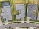 An aerial view of the community with the homes having well manicured lawns and a nearby road at 8946 Ivy Stark Blvd, Wesley Chapel, FL 33545