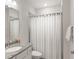 A cozy bathroom featuring a vanity sink, toilet, and shower with curtain at 8946 Ivy Stark Blvd, Wesley Chapel, FL 33545