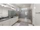 Modern bathroom with double vanity, granite counters and glass shower at 8946 Ivy Stark Blvd, Wesley Chapel, FL 33545