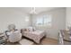 Cozy bedroom featuring a window with shutter blinds, stylish lighting, and a vanity at 8946 Ivy Stark Blvd, Wesley Chapel, FL 33545