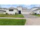 Charming home with a well-manicured lawn and a neatly paved driveway at 8946 Ivy Stark Blvd, Wesley Chapel, FL 33545