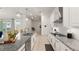 The kitchen features granite countertops, stainless steel appliances, and barstool seating at 8946 Ivy Stark Blvd, Wesley Chapel, FL 33545