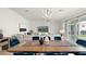 Bright and airy living room with a large sofa, access to the backyard, and modern decor at 8946 Ivy Stark Blvd, Wesley Chapel, FL 33545