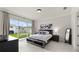 Beautiful main bedroom featuring sliding glass doors leading to the backyard at 8946 Ivy Stark Blvd, Wesley Chapel, FL 33545