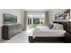 Spacious main bedroom with large dresser and sliding glass doors to the outside at 8946 Ivy Stark Blvd, Wesley Chapel, FL 33545