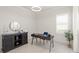 Bright home office featuring a modern desk, comfortable chair, and a stylish cabinet at 8946 Ivy Stark Blvd, Wesley Chapel, FL 33545
