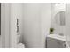 Powder room featuring grey vanity, vessel sink, round mirror and decorative greenery for an elegant and functional space at 8946 Ivy Stark Blvd, Wesley Chapel, FL 33545