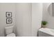 Powder room featuring grey vanity, vessel sink, round mirror, decorative greenery and starfish shell art at 8946 Ivy Stark Blvd, Wesley Chapel, FL 33545