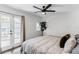 Bright bedroom featuring French doors, light hardwood floors, and a black ceiling fan at 930 23Rd N Ave, St Petersburg, FL 33704