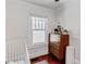 Bright Bedroom area with a wood dresser and hardwood flooring near window with natural light at 930 23Rd N Ave, St Petersburg, FL 33704