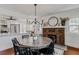 Bright dining room with hardwood floors, brick fireplace, and modern light fixture at 930 23Rd N Ave, St Petersburg, FL 33704