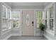 Sunroom entryway with a decorative glass door and multiple windows allowing natural light at 930 23Rd N Ave, St Petersburg, FL 33704
