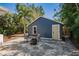 Detached single-car garage featuring a seating area and mature landscaping at 930 23Rd N Ave, St Petersburg, FL 33704