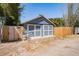 Exterior shot of the detached two-car garage in backyard, with a wooden privacy fence at 930 23Rd N Ave, St Petersburg, FL 33704
