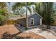 Detached single-car garage featuring an outdoor seating area and mature landscaping at 930 23Rd N Ave, St Petersburg, FL 33704