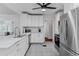 Well-lit kitchen featuring stainless steel appliances, white cabinets, and tile flooring at 930 23Rd N Ave, St Petersburg, FL 33704