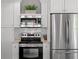 Modern kitchen with stainless steel microwave, oven, and refrigerator with classic white cabinets at 930 23Rd N Ave, St Petersburg, FL 33704