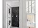 A convenient laundry area featuring stacked washer and dryer, and cute wall decor at 930 23Rd N Ave, St Petersburg, FL 33704