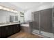 A modern bathroom with a soaking tub, glass-enclosed shower, and a double vanity at 930 57Th N Ave, St Petersburg, FL 33703
