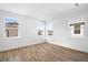 Bright bedroom with wood-look tile flooring and multiple windows offering natural light at 930 57Th N Ave, St Petersburg, FL 33703
