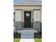 Charming home entrance featuring a dark-green front door with brick-base pillars at 930 57Th N Ave, St Petersburg, FL 33703