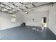 An attached garage with painted block walls and a sealed floor at 930 57Th N Ave, St Petersburg, FL 33703