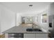 Spacious open floor plan with kitchen island overlooking living area with wood floors at 930 57Th N Ave, St Petersburg, FL 33703