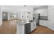 Open-concept kitchen featuring a granite island, stainless steel appliances, and ample natural light at 930 57Th N Ave, St Petersburg, FL 33703