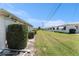 Backyard featuring a neatly maintained lawn with an orderly row of shrubbery for a tidy outdoor view at 9740 45Th N St, Pinellas Park, FL 33782