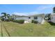 Backyard featuring a neatly maintained lawn with an orderly row of shrubbery for a tidy outdoor view at 9740 45Th N St, Pinellas Park, FL 33782