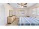 Well-lit bedroom with ceiling fan, neutral walls, and carpet at 9740 45Th N St, Pinellas Park, FL 33782
