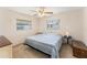 Bright bedroom with carpet, fan, and natural light from windows at 9740 45Th N St, Pinellas Park, FL 33782
