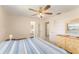 Bedroom view showcasing ceiling fan, ensuite bathroom and closet access at 9740 45Th N St, Pinellas Park, FL 33782