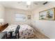 Functional bedroom with a floral comforter, ceiling fan, and a work space perfect for any homeowner at 9740 45Th N St, Pinellas Park, FL 33782