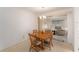 Dining area with a wooden table set for four, adjacent to the living room and kitchen at 9740 45Th N St, Pinellas Park, FL 33782