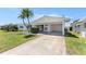 Inviting home featuring a covered carport, well-kept lawn, and a welcoming front entrance at 9740 45Th N St, Pinellas Park, FL 33782