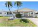 Charming single-story home with a well-maintained lawn and beautiful palm trees in the front yard at 9740 45Th N St, Pinellas Park, FL 33782