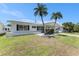 A cozy single-story home featuring a covered carport, well-kept lawn, and tasteful landscaping at 9740 45Th N St, Pinellas Park, FL 33782