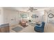 Cozy living room featuring large window, ceiling fan, comfortable seating, and bright, natural light at 9740 45Th N St, Pinellas Park, FL 33782
