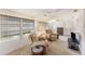 Spacious living room featuring comfortable seating, multiple windows for natural light, and ceiling fans at 9740 45Th N St, Pinellas Park, FL 33782