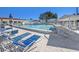 Community pool featuring lounge chairs and umbrella tables for residents' enjoyment at 9740 45Th N St, Pinellas Park, FL 33782