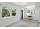 Bright dining room with plush carpeting, natural light, and neutral color palette at 10035 63Rd N Ave # 12, St Petersburg, FL 33708