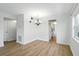 Light and bright dining room with wood-look flooring, chandelier, and views of the kitchen at 10035 63Rd N Ave # 12, St Petersburg, FL 33708