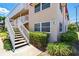 Close up exterior view of unit showing stairs, railings and landscaping at 10035 63Rd N Ave # 12, St Petersburg, FL 33708