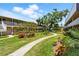 Beautiful courtyard view of building exterior with lush landscaping and green space at 10035 63Rd N Ave # 12, St Petersburg, FL 33708